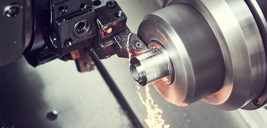 CNC lathe turning a rotationally symmetric metal component